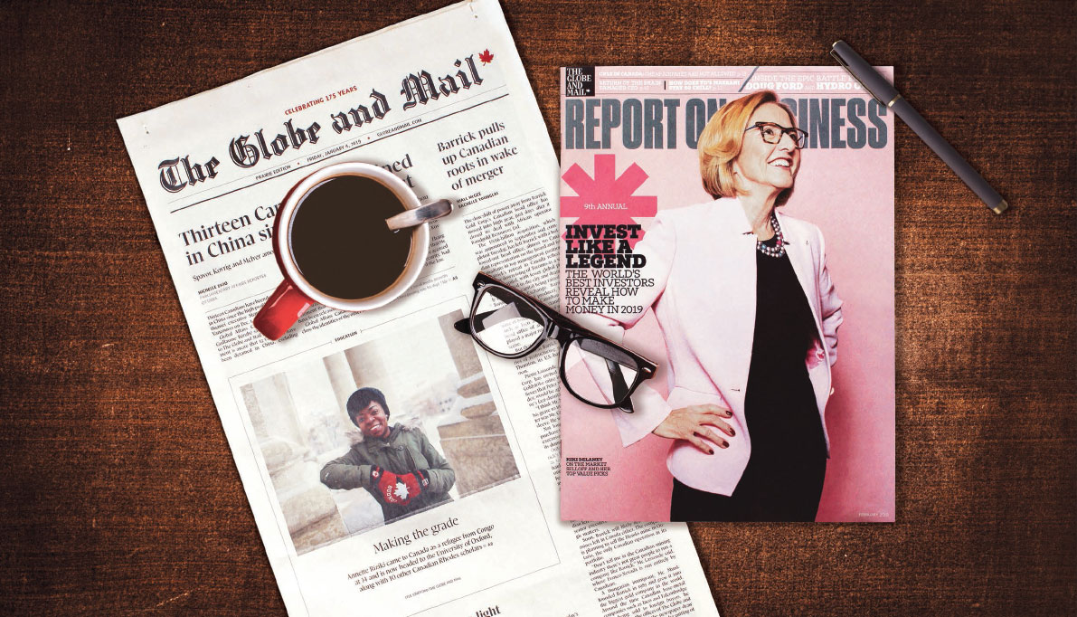 A copy of The Globe and Mail and Report on Business are on a table with glasses and a coffee cup sitting on top of them.