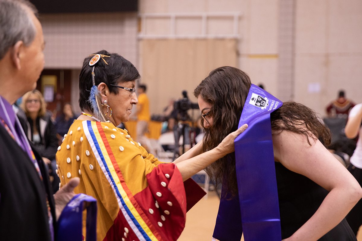 Grandmother-in-Residence Lorraine Cameron-Munro and a student at the 30th Annual Traditional Graduation Pow Wow in May.