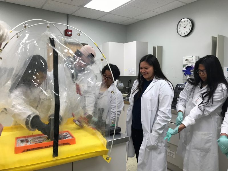 Students do an activity in a BioSafety mobile lab.