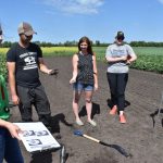 Kristen MacMillan with students in field