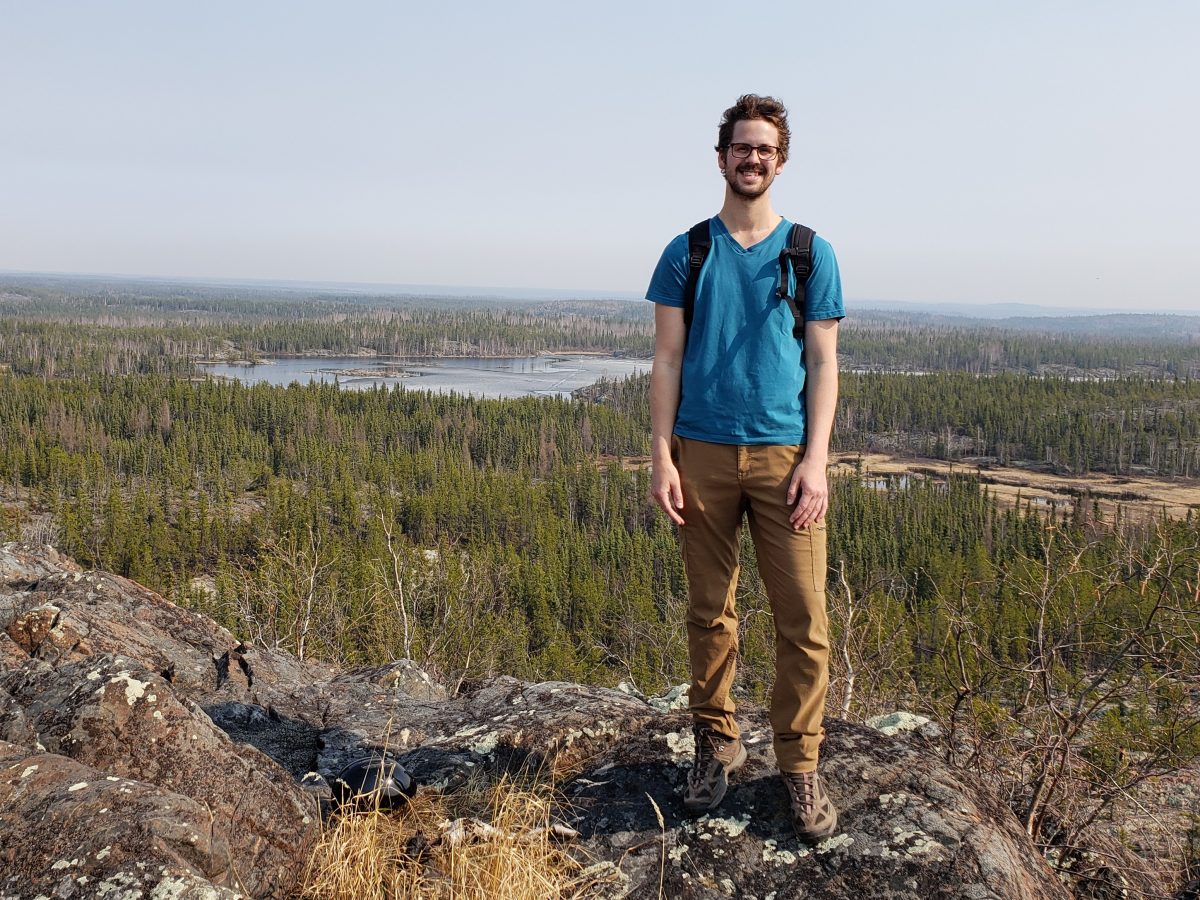 MA Student Jason Carrie standing on rocky landscape in Yellowknife NWT