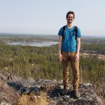 MA Student Jason Carrie standing on rocky landscape in Yellowknife NWT
