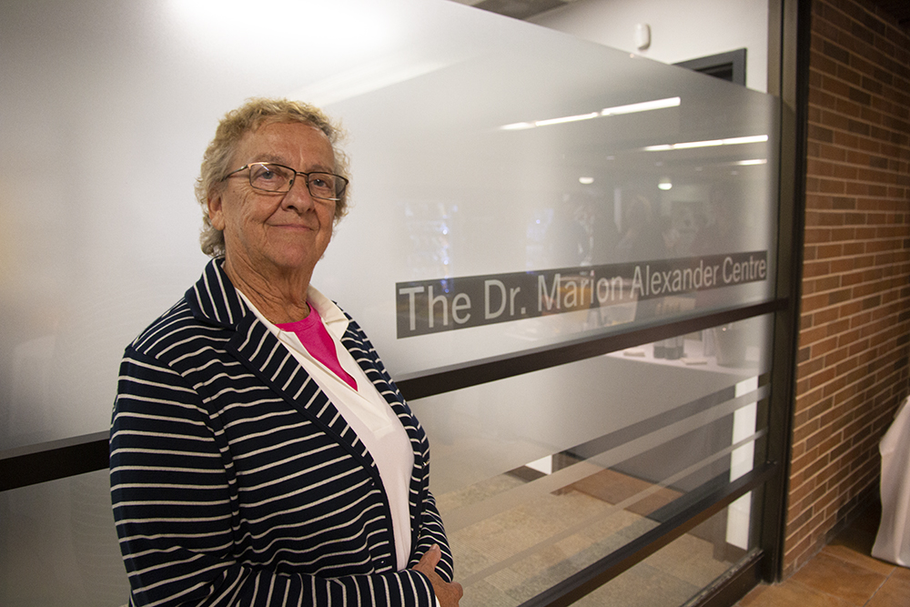 Dr. Marion Alexander in front of the newly-named Dr. Marion Alexander Centre