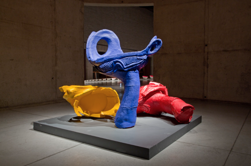 large yellow, blue and red sculptures of squeezed toys