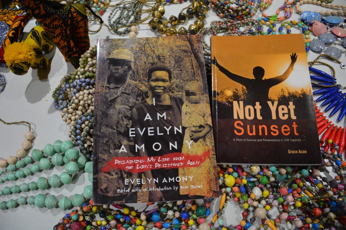 This image shows Grace and Evelyn's books lying on hand-made gifts they made to raise money for LRA escapees.