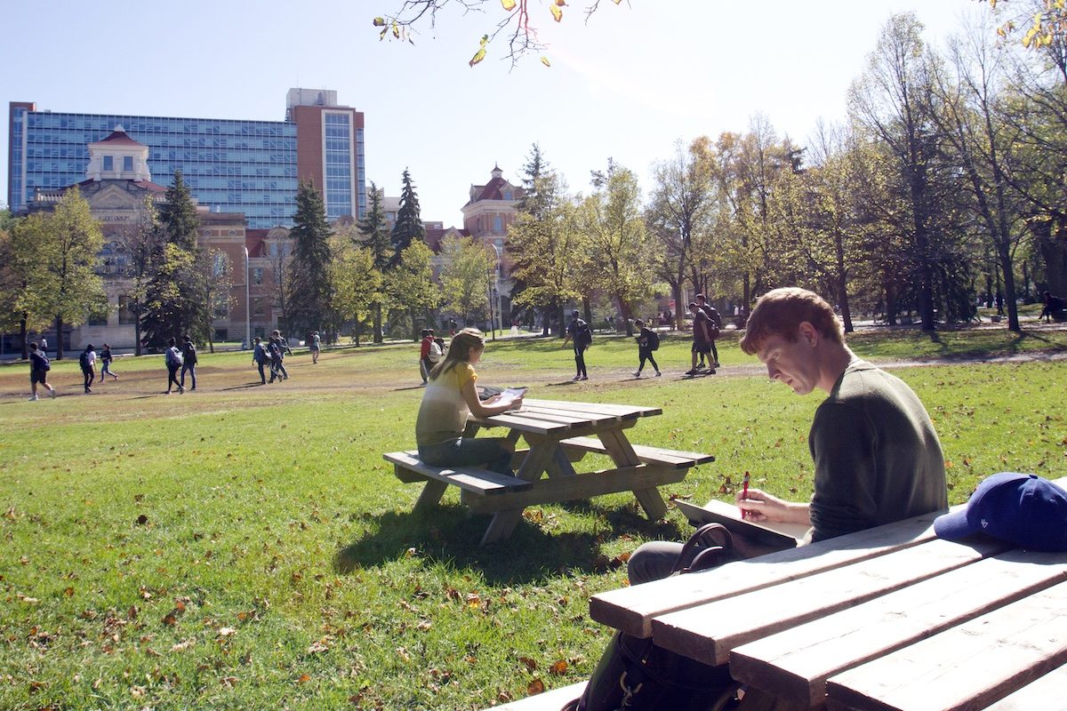 students on the quad at the U of M with Pembina Hall residence behind