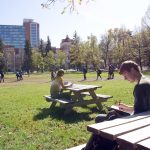 students on the quad at the U of M with Pembina Hall residence behind