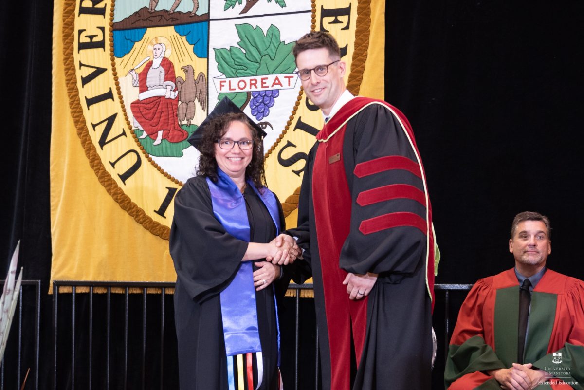 Bonnie Murray, Applied Counselling program grad, is congratuated by Paul Jenkins, Manager, Delivery, Extended Education.