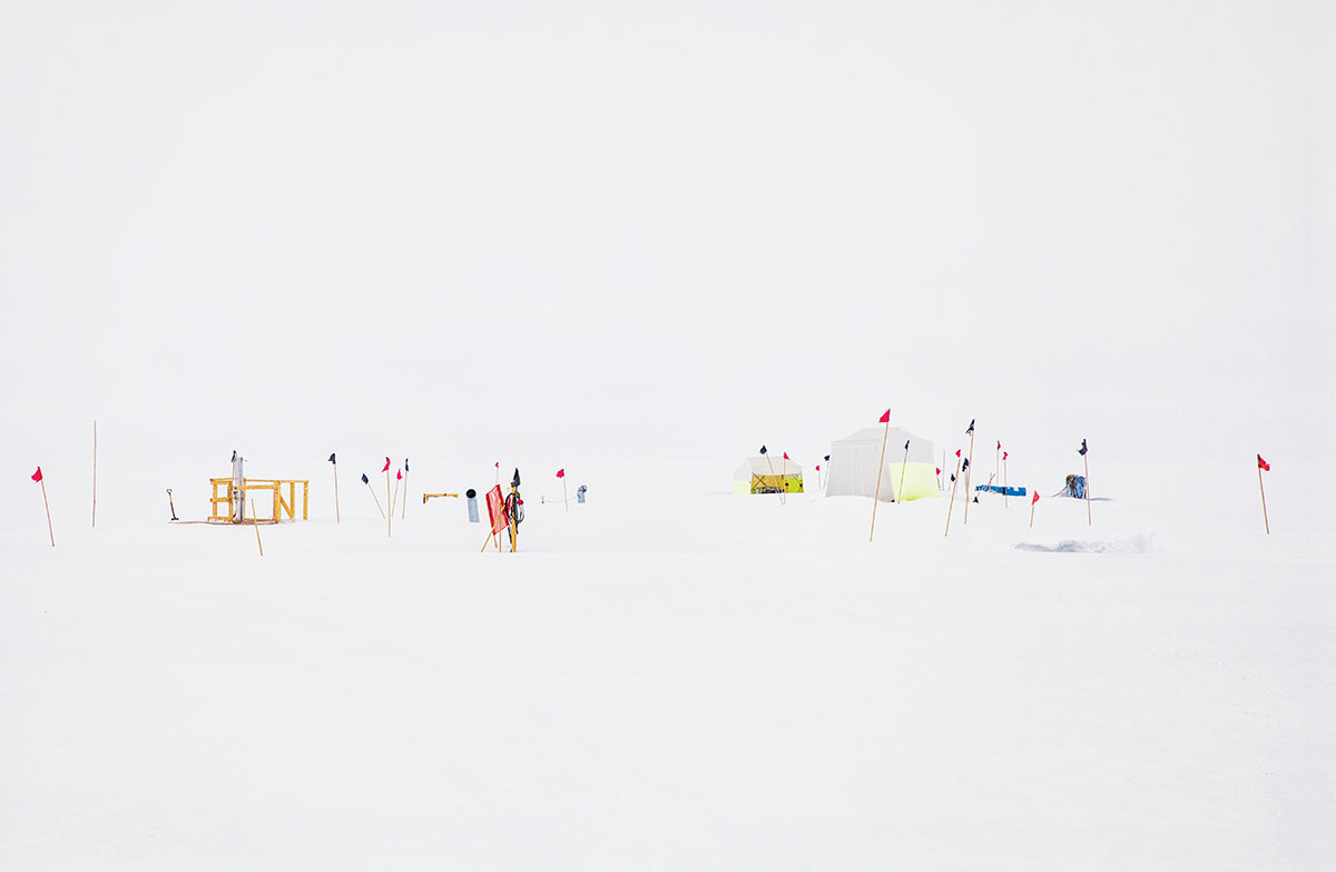 On the Greenland ice sheet, where visibility can be low, flags help mark camp boundaries. The research site operates in these remote and extreme conditions for 90 days a year //  photo by ANNA FILIPOVA