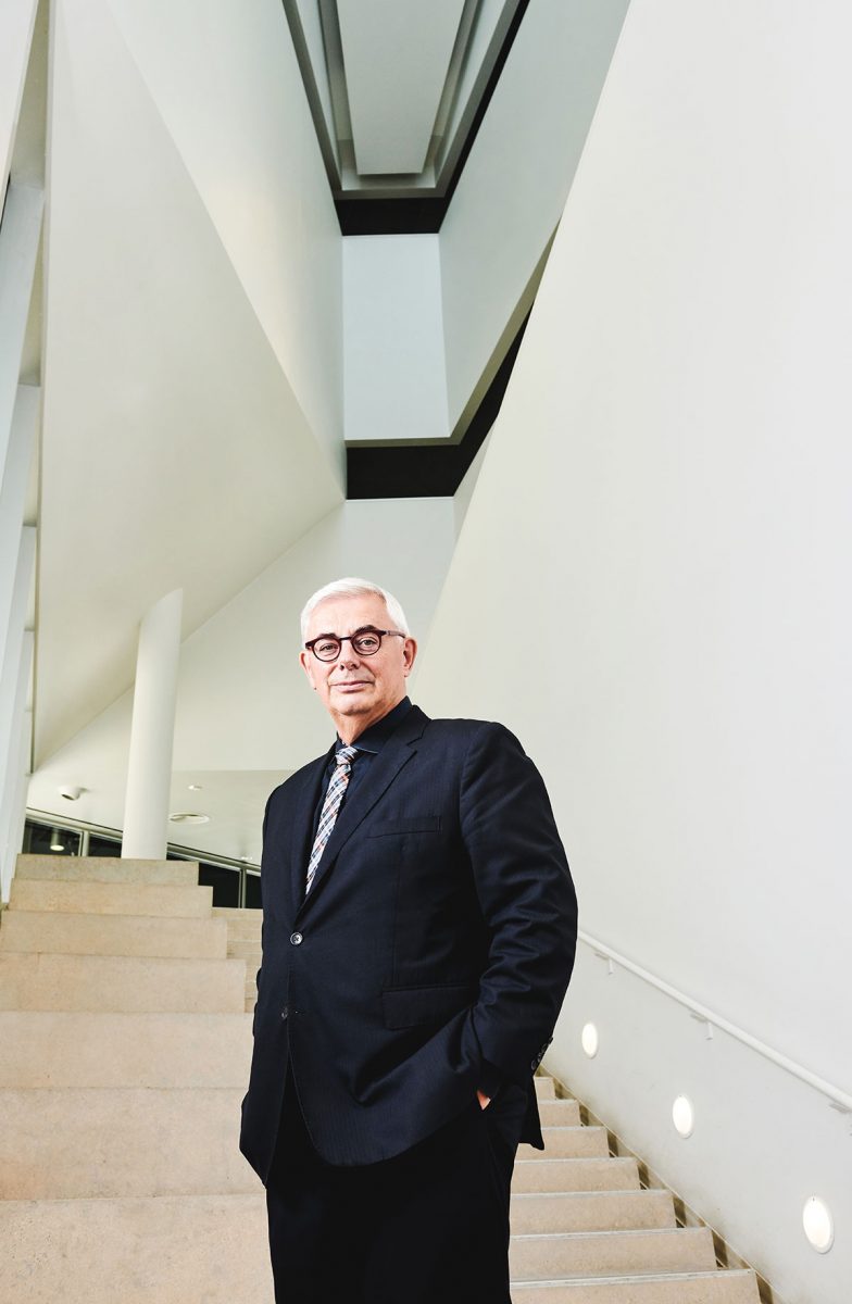 David Barnard stands at the bottom of a set of stairs.