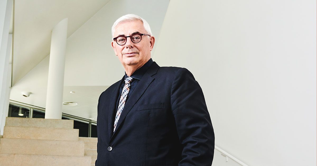 David Barnard stands at the bottom of a flight of stairs.