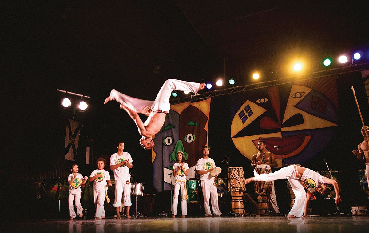 People perform acrobatic flips in a Capoeira demonstration at the Brazilian Pavilion in Folklorama.