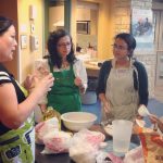 Instructor teaches students how to prepare food in Migizii Agamik.