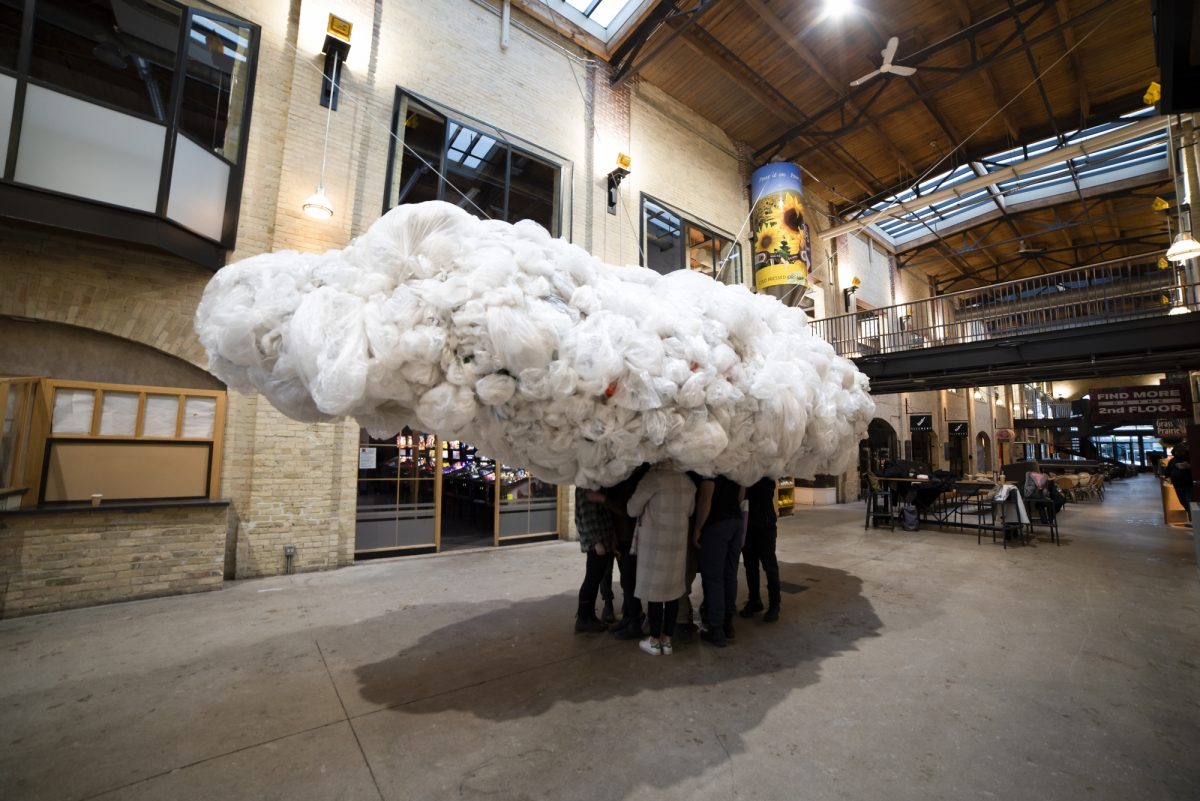 Students Standing in a cloud of plastic for art installation