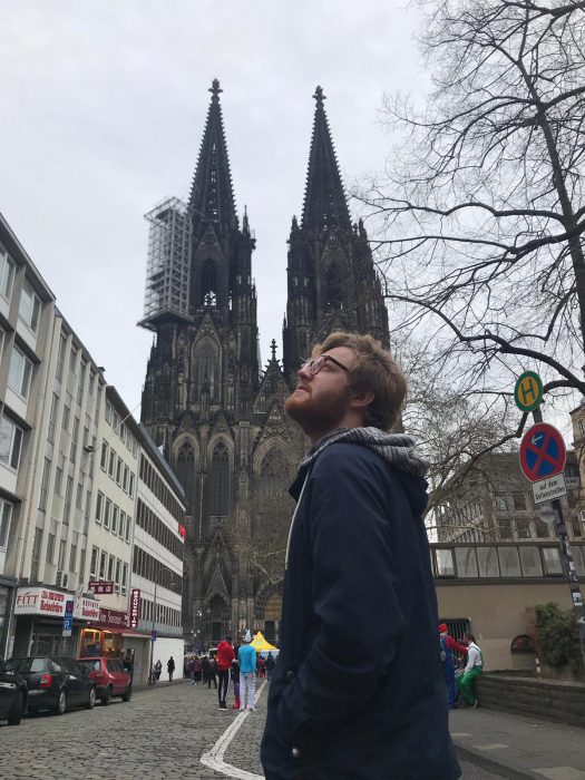 Timm Giessbrecht in front of historic building in Cologne, Germany