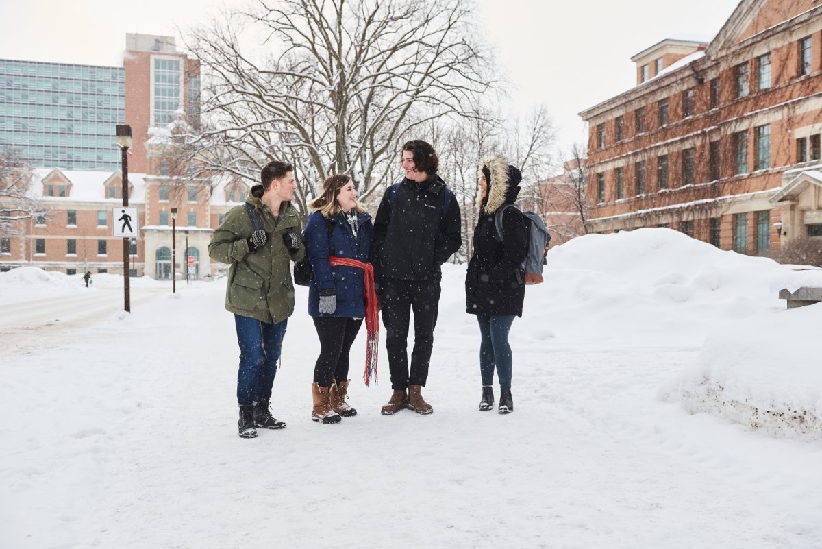 Four students outside in winter