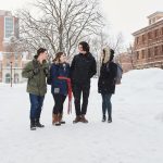 Four students outside in winter