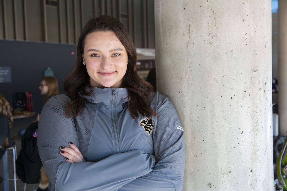 Deanna Pesun in the ALC Agora. She's wearing a U of M Bisons jacket.