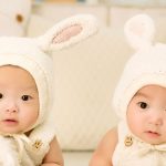 Twin babies in knitted bunny ears
