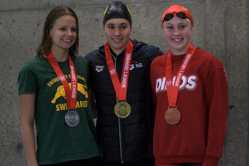 Kelsey Wog with other swimmers win medals