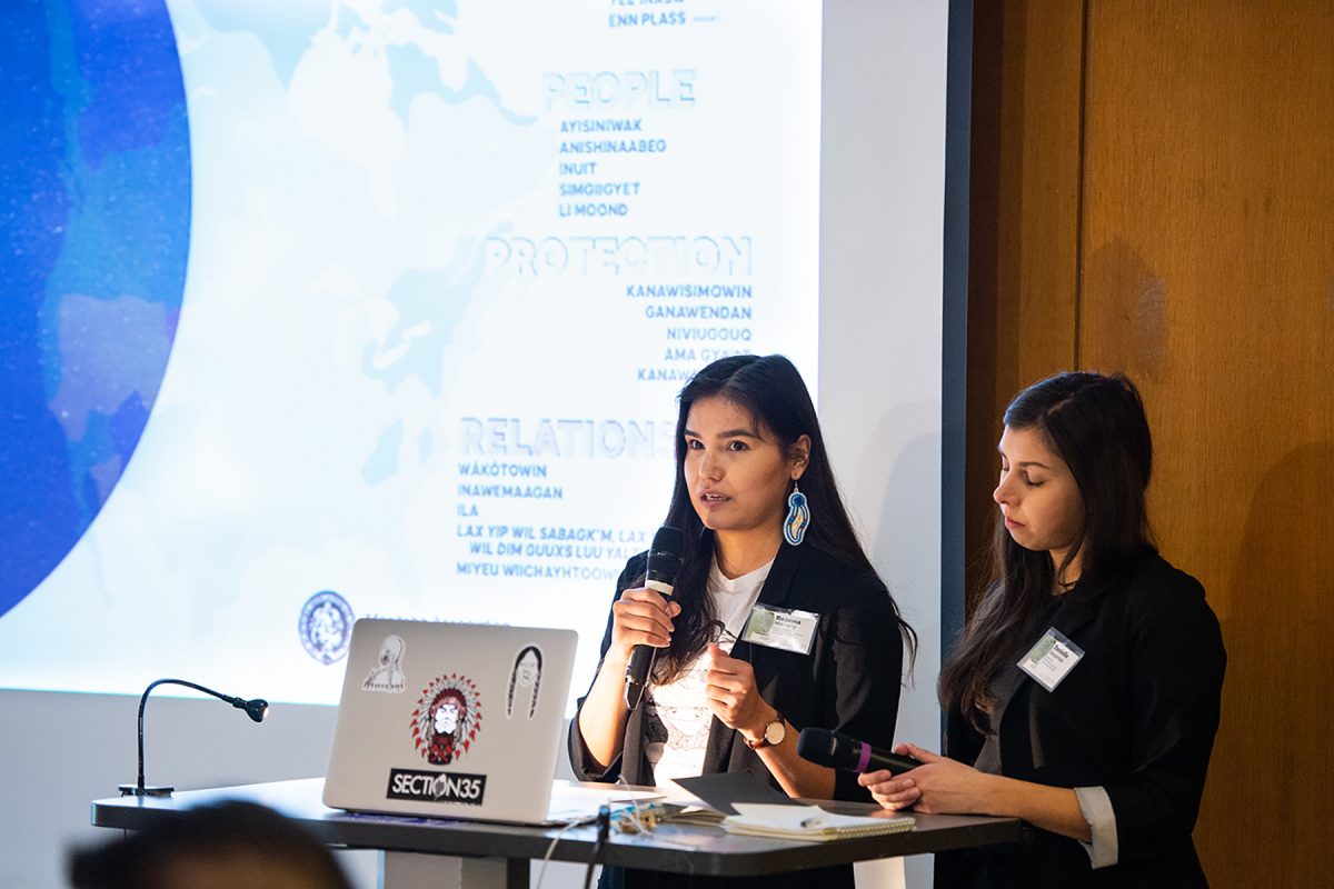 Indigenous architecture student Reanna Merasty and colleague presenting in front of a power point.