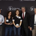 The research team descibed in the article receiving a trophy for best presentation at a ceremony in New York.