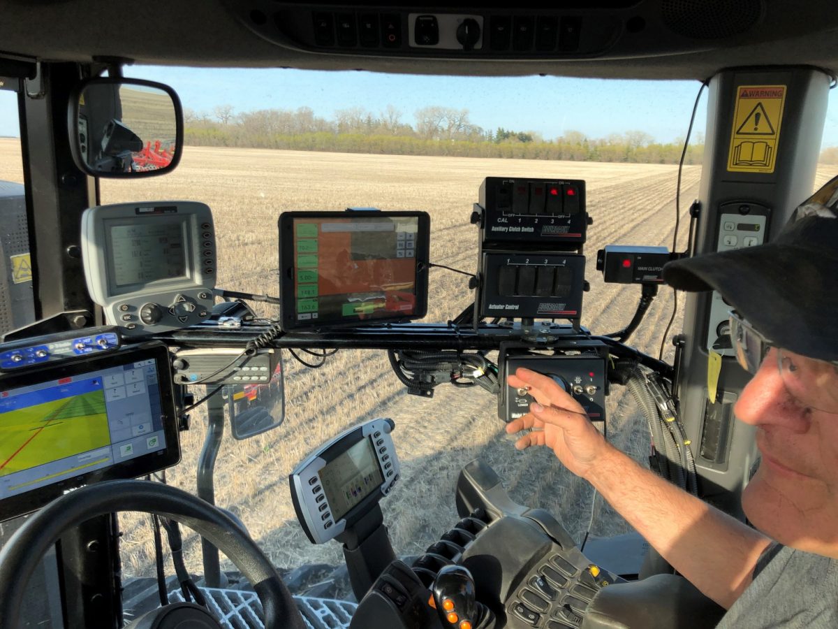 digital agriculture equipment in a truck with operator on a field of crops
