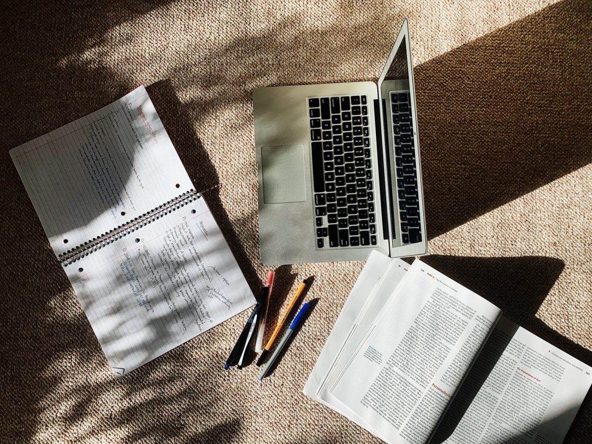 laptop and notebook on the floor