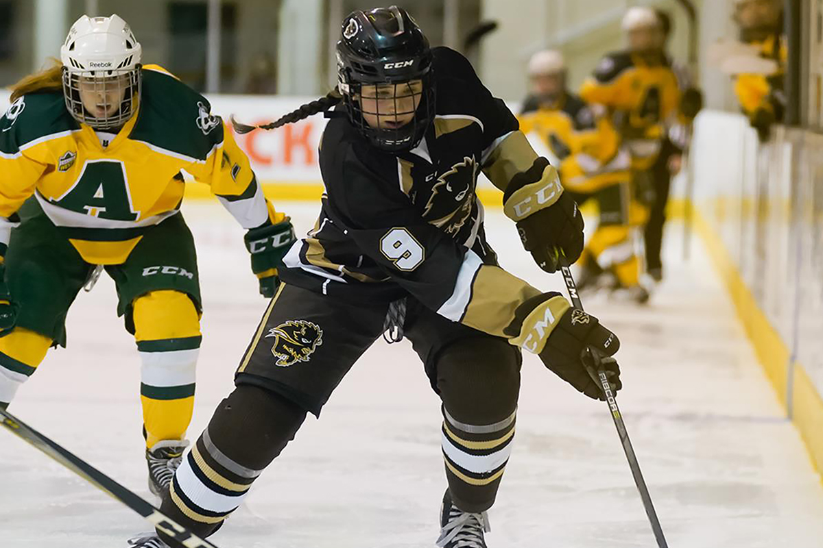 hockey player chasing down puck