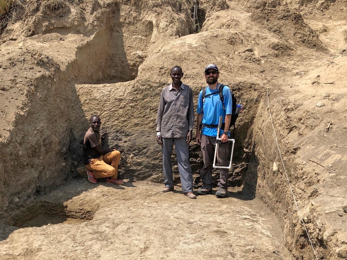 University of Manitoba assistant professor P. Durkin (right) studies sedimentary layers at Oldupai Gorge, Tanzania with local Maasai employees (left). Photograph: Stephen Hubbard