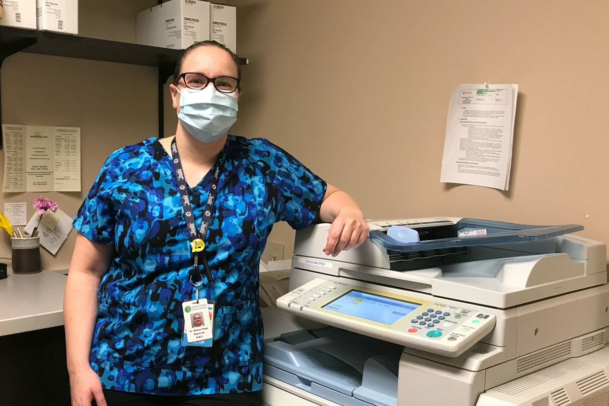 Dr. Allison Paige stands beside the fax machine at Kildonan Medical Centre.