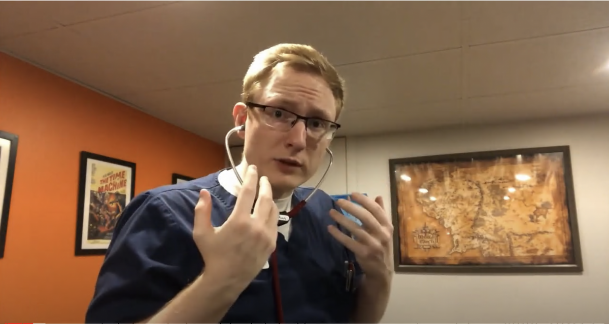 Nursing student demonstrates how to use a stethoscope.