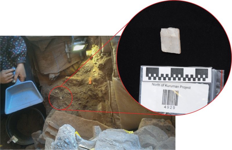 An overhead shot of the archeological dig, and a pull out image of a white rectangular crystal