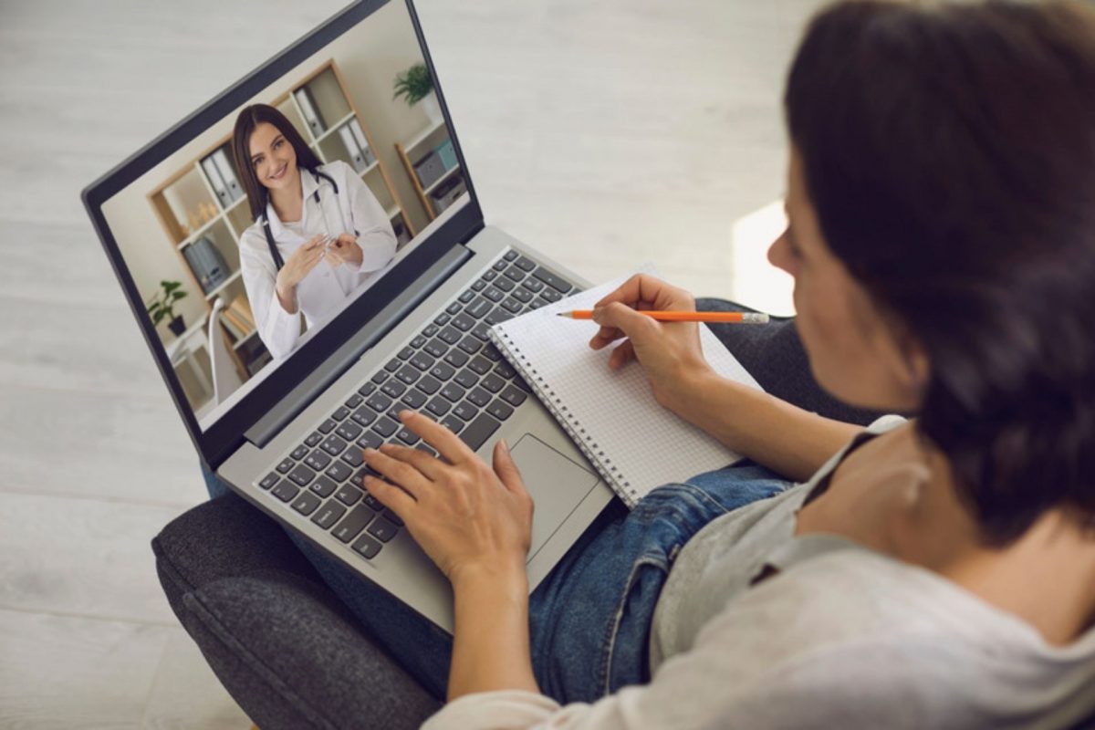 Patient speaks with a doctor via video chat on a laptop.