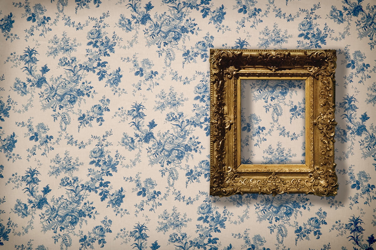 A photo hangs on a vintage wallpaper.