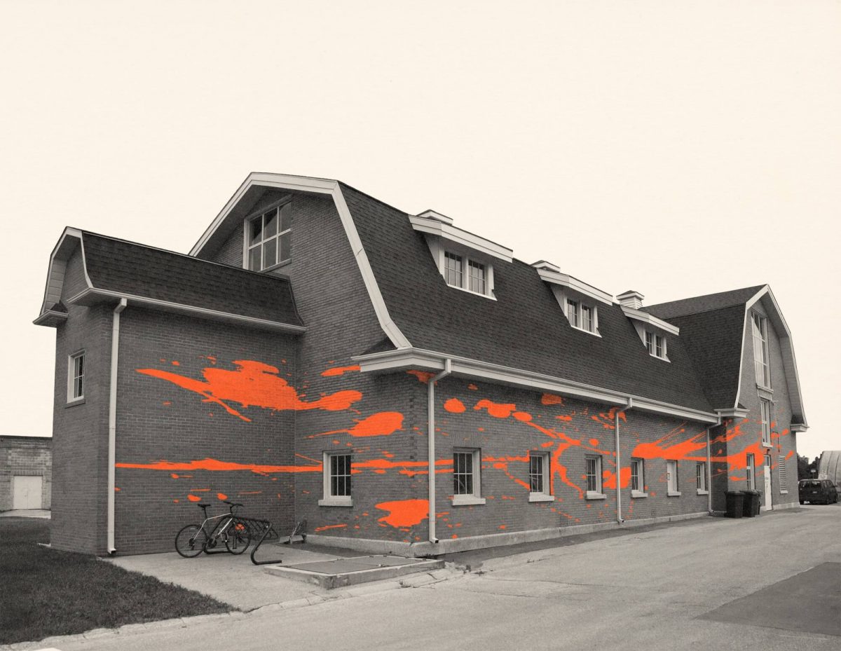 The U of M art barn, with graphic orange paint splatters on it.