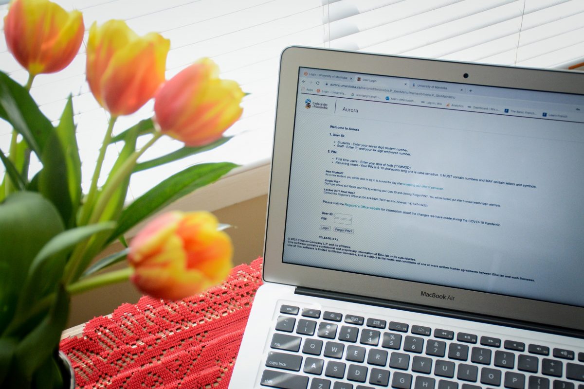 Laptop and flowers on desk