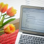 Laptop and flowers on desk