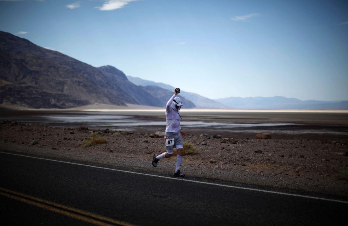 Glen running at the side of a road in the desert.