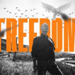 David Milgaard stands in front of an open landscape, with the word 'freedom' behind him.