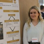 a student in frot of her research poster