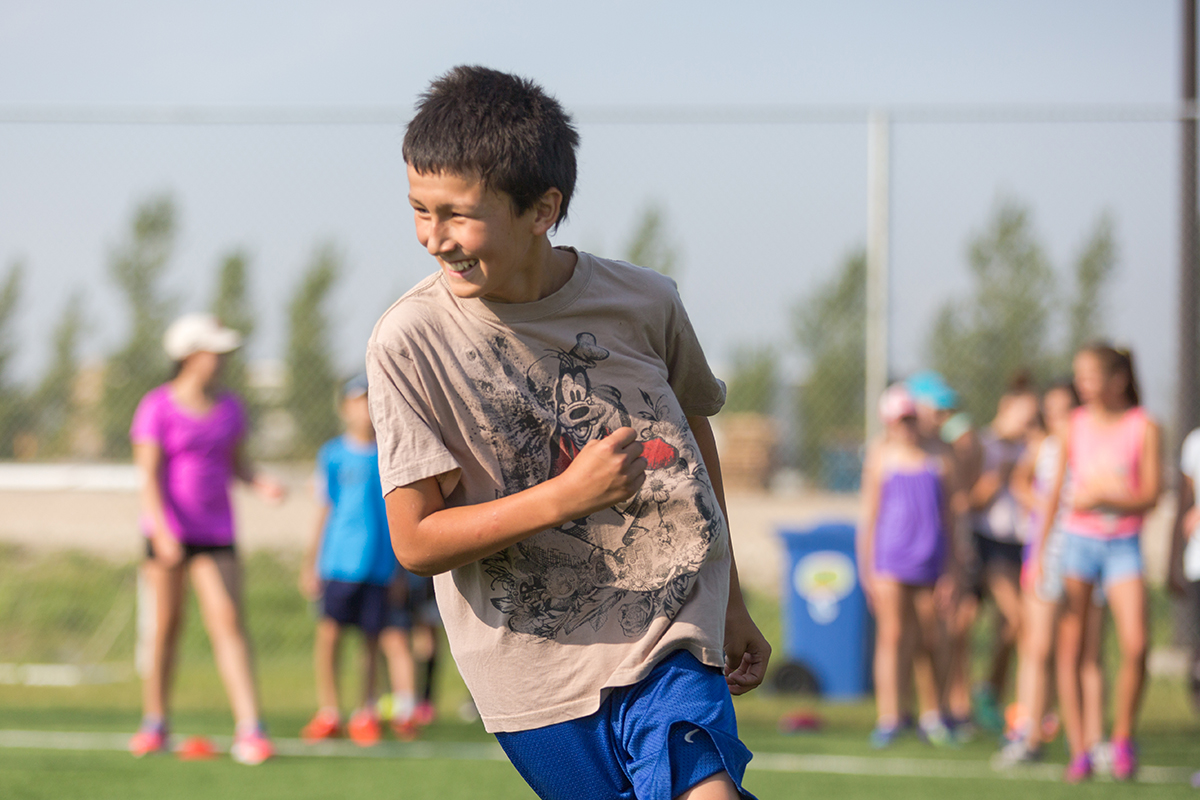 boy pictured playing outdoors at camp