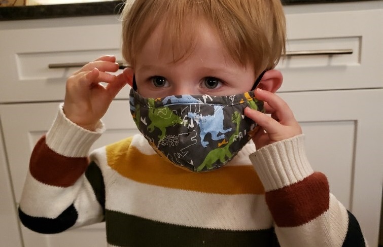A child wears a face mask.