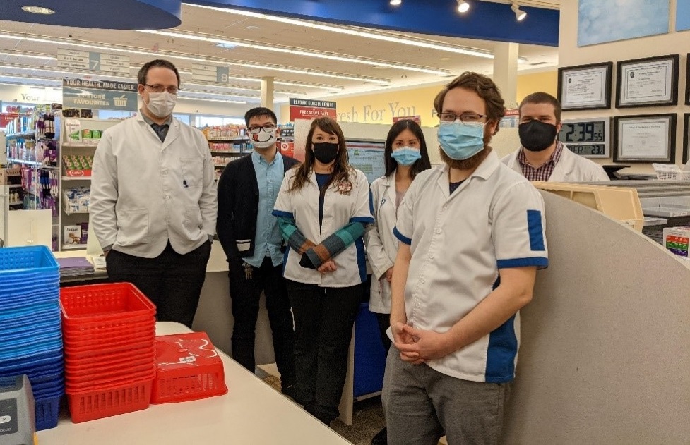 Pharmacy students, preceptors and pharmacy staff stand in the Southdale Shoppers Drug Mart.