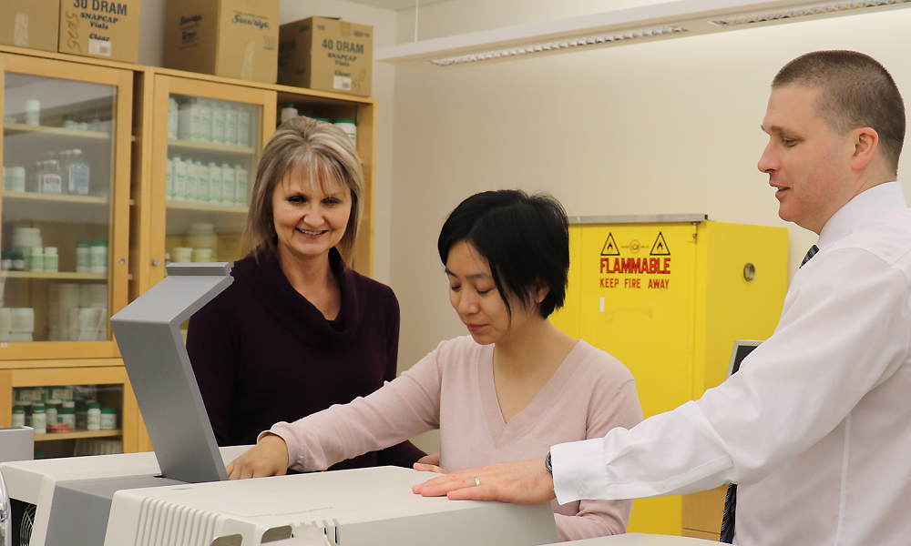 Dr. Sheryl Zelenitsky (left), student Wenxia Luo and faculty member Dr. Ted Lakowski in a lab at the College of Pharmacy