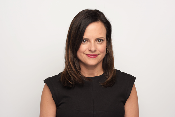 Asper alumna, Jennifer McNeill, wearing a black shirting smiling.