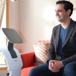 Researcher Amine Choukou with a telepresence robot.