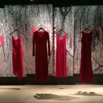 Red dresses hanging on display