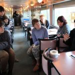 Sarah Ciurysek (right) in discussion with her visual art students during a course critique on the train to Churchill, May 2017