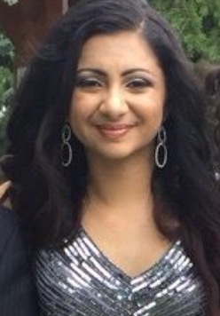 closeup of woman with dark hair and sparkly silver top